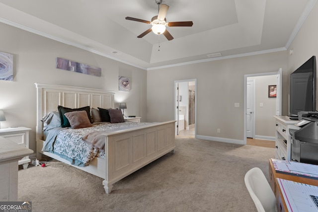 bedroom featuring a tray ceiling, ornamental molding, light carpet, ceiling fan, and baseboards