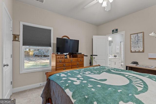 bedroom with visible vents, baseboards, ensuite bath, ceiling fan, and carpet flooring