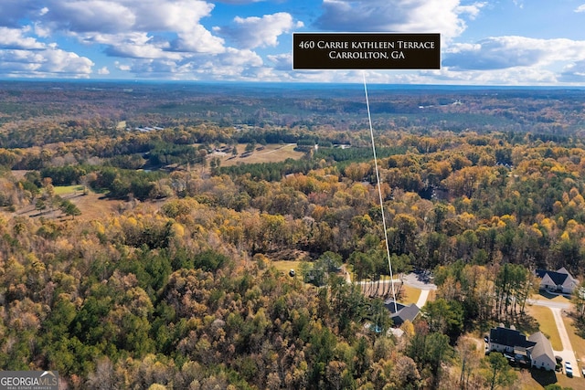 birds eye view of property with a view of trees