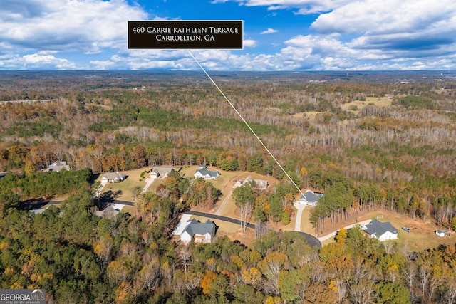 birds eye view of property with a view of trees