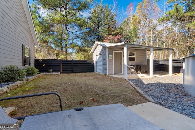 view of yard with an outdoor structure and fence