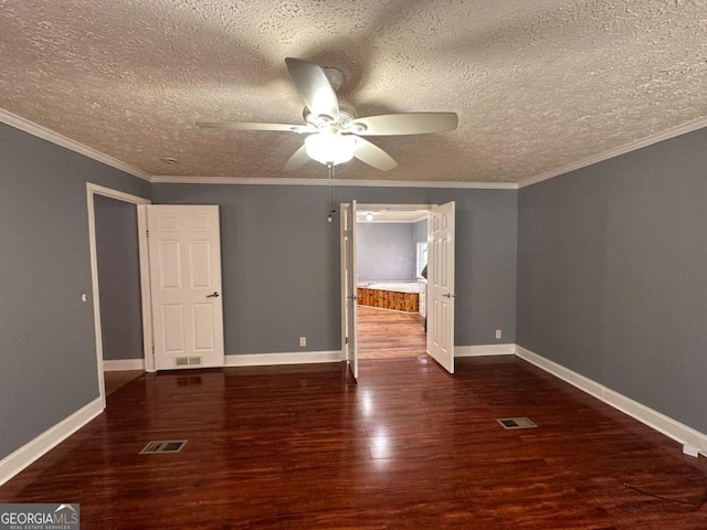 unfurnished bedroom featuring visible vents, crown molding, baseboards, and wood finished floors