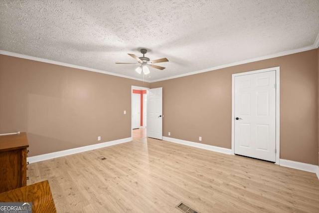 interior space featuring light wood-type flooring, baseboards, and crown molding