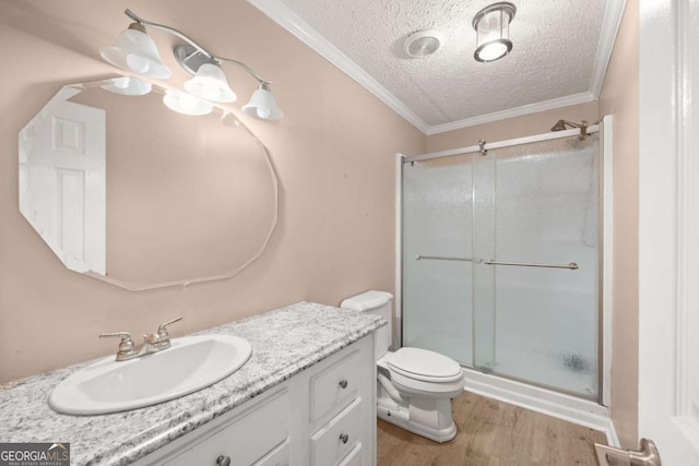 bathroom with a textured ceiling, wood finished floors, vanity, a shower stall, and crown molding