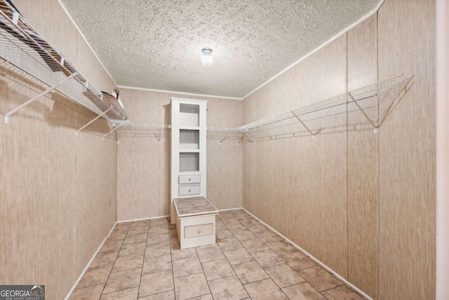 spacious closet featuring tile patterned flooring