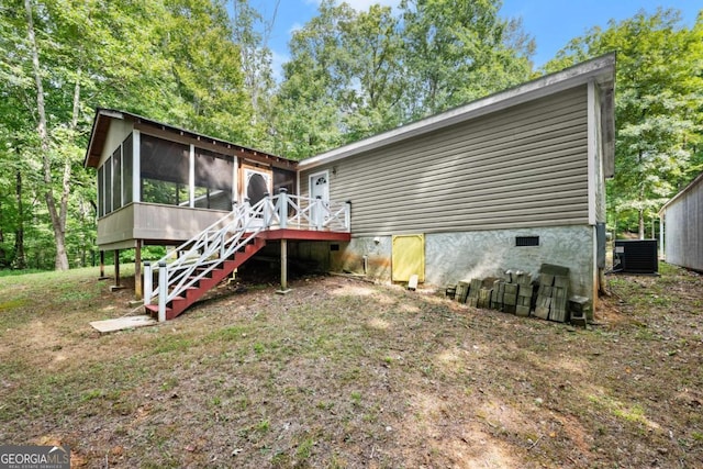 rear view of property featuring cooling unit, a sunroom, and stairs