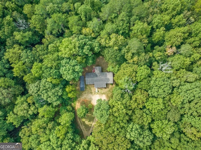 drone / aerial view featuring a wooded view