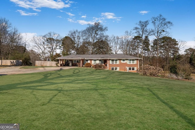 view of front of property featuring driveway, a front yard, and fence