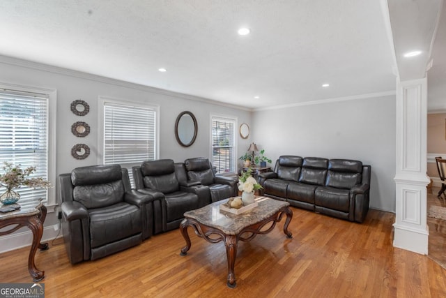 living area featuring crown molding, recessed lighting, ornate columns, light wood-type flooring, and baseboards