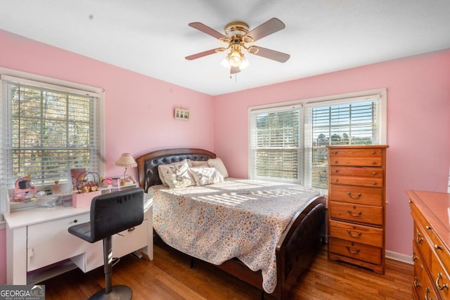 bedroom with ceiling fan and wood finished floors