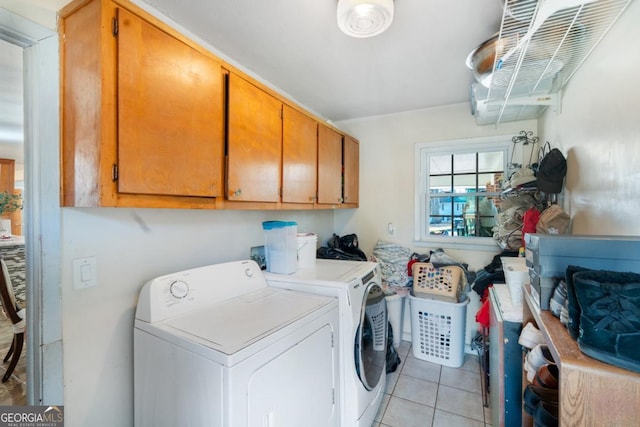 clothes washing area with cabinet space, separate washer and dryer, and light tile patterned flooring