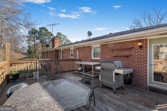 wooden terrace with outdoor dining area