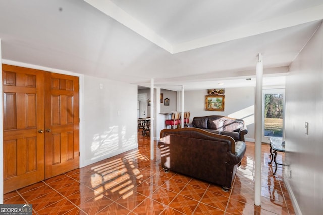 living area featuring tile patterned floors and baseboards