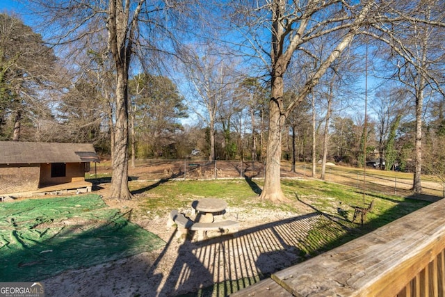 view of yard with an outdoor structure, a fire pit, and fence