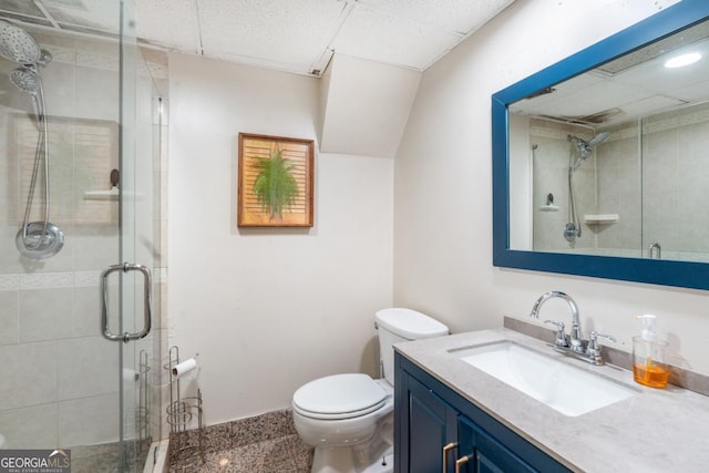 bathroom with a stall shower, vanity, and toilet