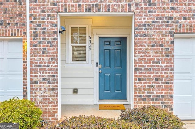 property entrance with brick siding