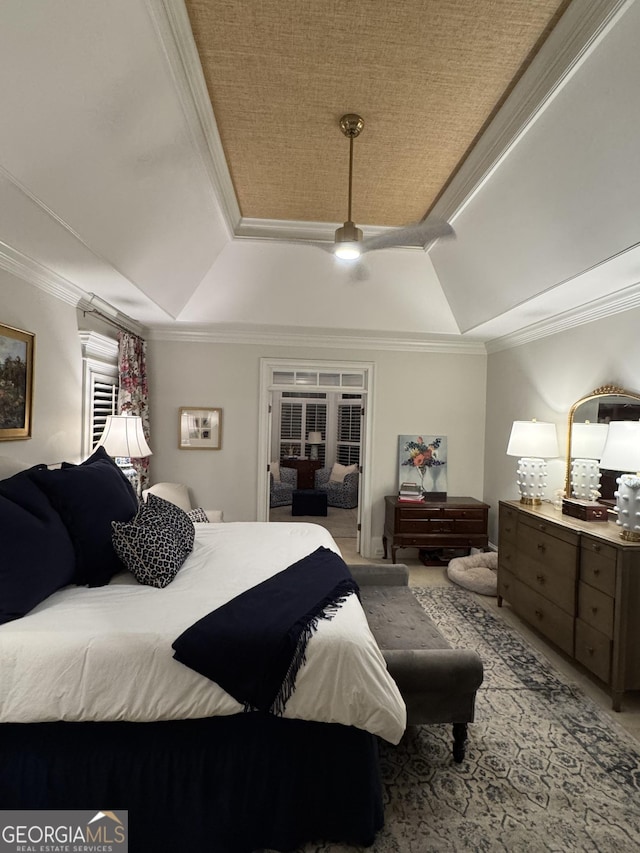 bedroom featuring ornamental molding, a tray ceiling, and vaulted ceiling