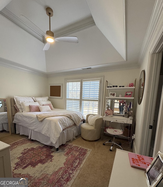 bedroom featuring visible vents, a raised ceiling, a ceiling fan, crown molding, and carpet floors