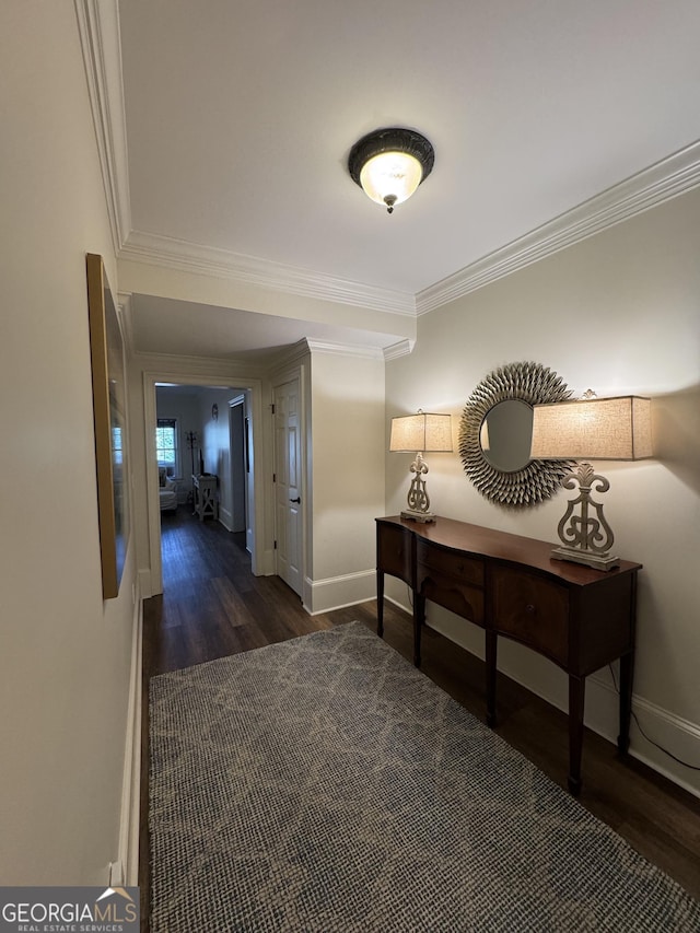 corridor with crown molding, baseboards, and wood finished floors