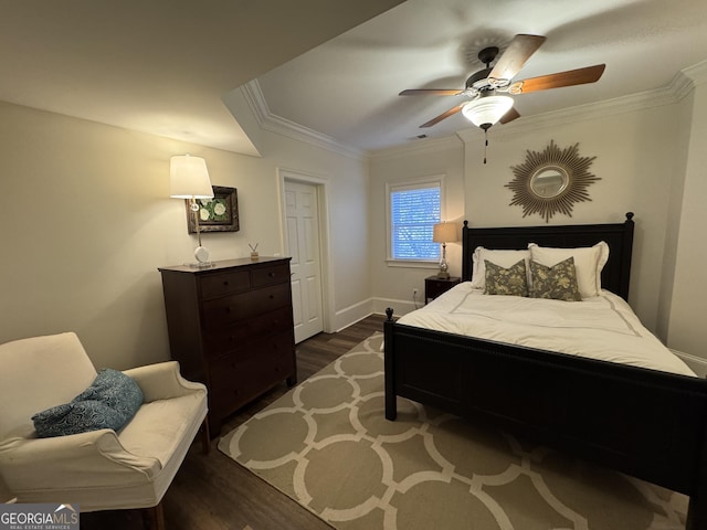 bedroom with baseboards, ceiling fan, ornamental molding, and dark wood-type flooring