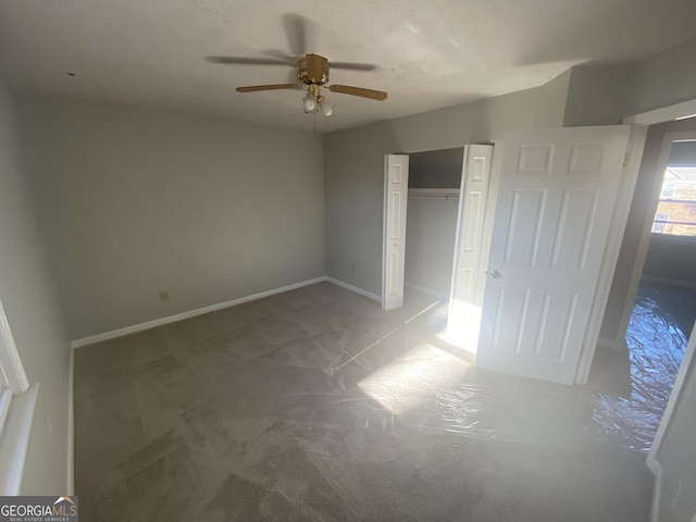 unfurnished bedroom with a ceiling fan, baseboards, and a closet