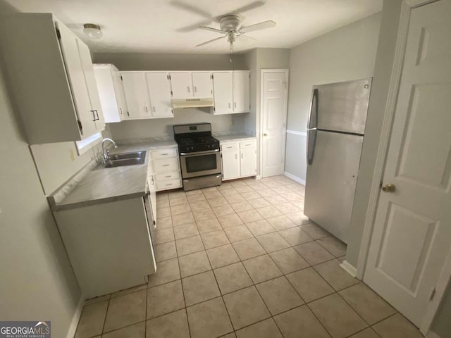 kitchen featuring light countertops, appliances with stainless steel finishes, white cabinetry, a sink, and under cabinet range hood