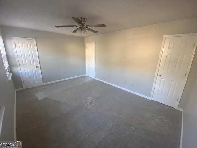 unfurnished bedroom featuring carpet, ceiling fan, and baseboards