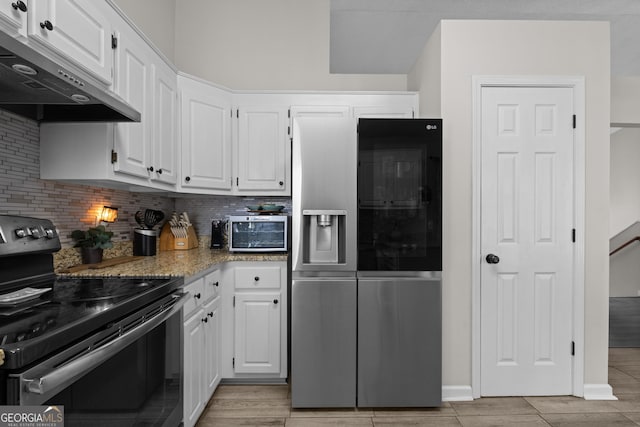 kitchen featuring electric range oven, white cabinets, under cabinet range hood, and stainless steel fridge with ice dispenser