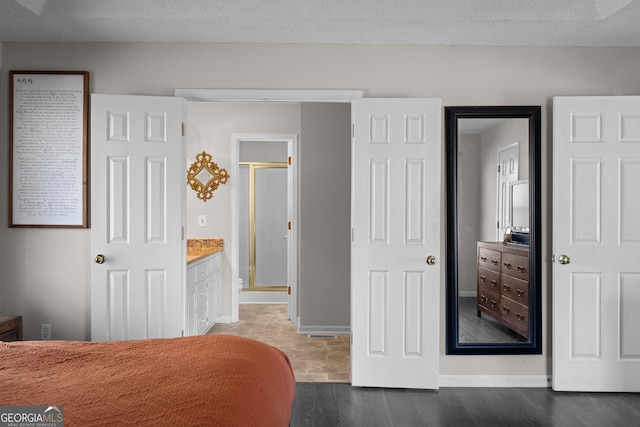 bedroom with baseboards and a textured ceiling