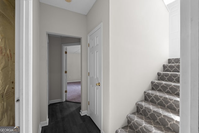 stairway featuring wood finished floors and baseboards