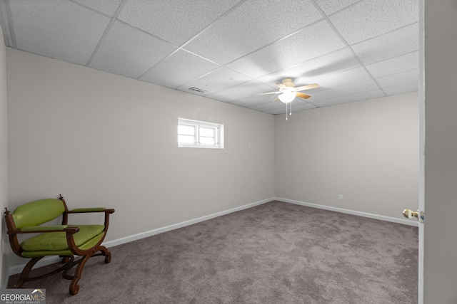 carpeted empty room with a paneled ceiling, visible vents, and baseboards