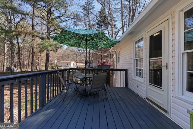 deck with outdoor dining area