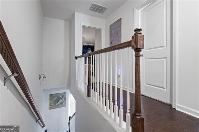 stairs featuring visible vents and wood finished floors