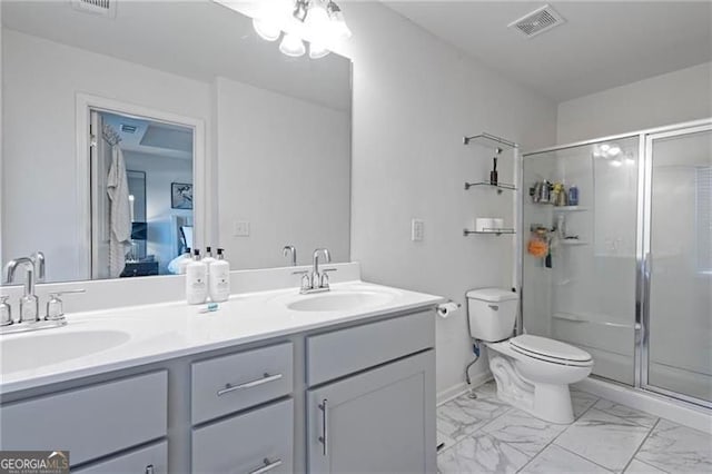 full bath with toilet, marble finish floor, visible vents, and a sink