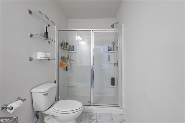 full bath featuring marble finish floor, baseboards, a shower stall, and toilet