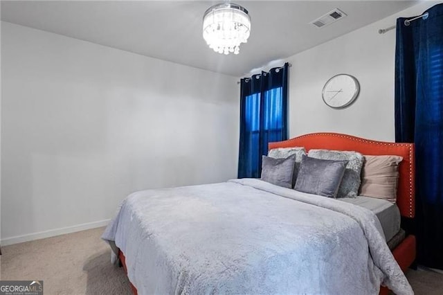 bedroom featuring a chandelier, carpet floors, visible vents, and baseboards