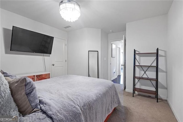 bedroom with carpet floors, visible vents, and baseboards