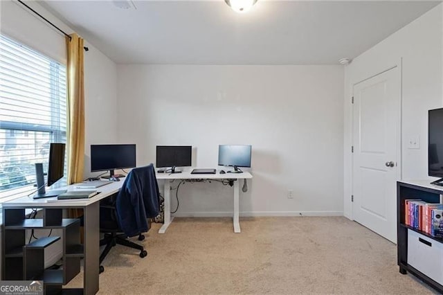 carpeted home office featuring baseboards