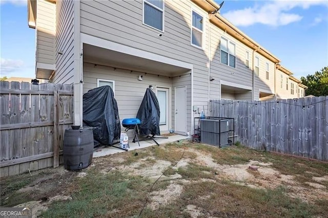 rear view of house with a patio area and a fenced backyard