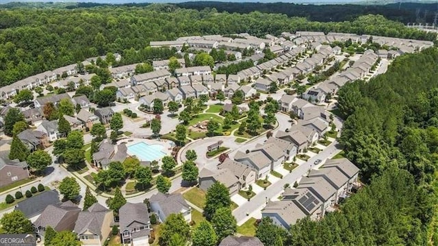 birds eye view of property with a forest view and a residential view