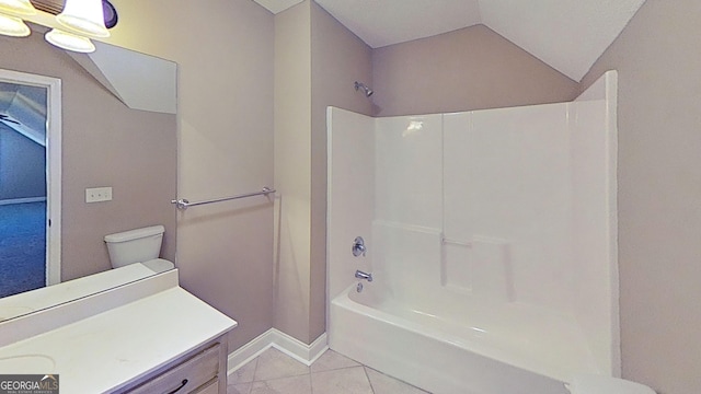 bathroom with bathtub / shower combination, tile patterned flooring, vanity, baseboards, and vaulted ceiling