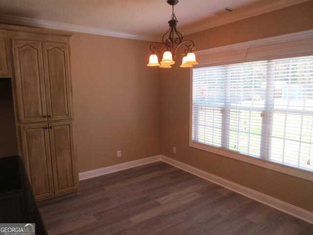 unfurnished dining area featuring an inviting chandelier, ornamental molding, dark wood-style flooring, and baseboards