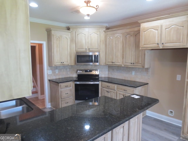 2026 Pin Oak Ter, Bonaire, GA 31005 - kitchen with appliances with stainless steel finishes, light brown cabinets, dark stone counters, baseboards, and ornamental molding