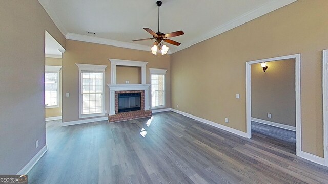 unfurnished living room featuring crown molding, dark wood-type flooring, baseboards, and ceiling fan