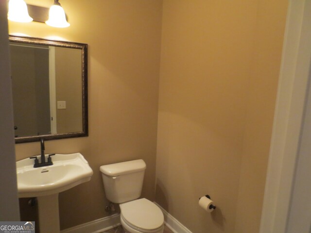 empty room with baseboards, a tray ceiling, wood finished floors, and visible vents