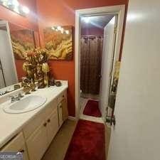 bathroom featuring curtained shower and vanity