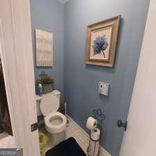 bathroom featuring toilet and baseboards