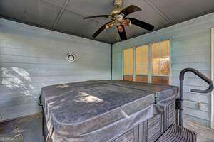 view of patio / terrace with a ceiling fan and a hot tub