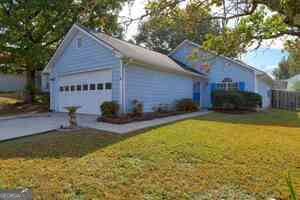 view of home's exterior featuring a garage and a lawn