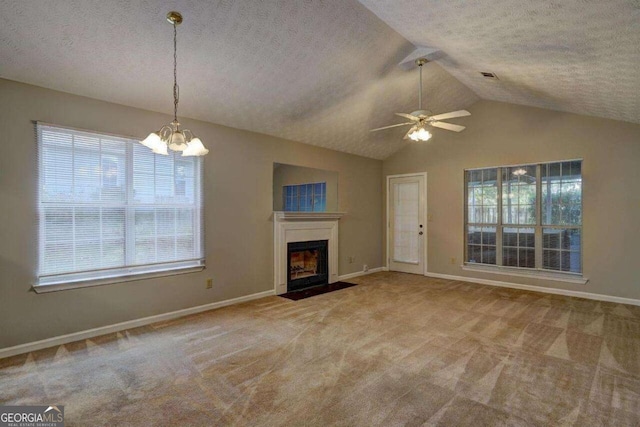 unfurnished living room with a textured ceiling, carpet flooring, a fireplace with flush hearth, baseboards, and vaulted ceiling